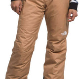 North Face Girls Freedom Insulated Pant 2024 - A pair of tan snow pants with a white logo on the left leg and black trim around the cuffs.