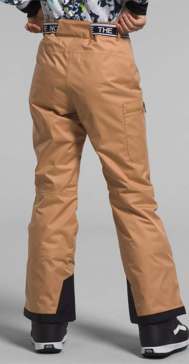 North Face Girls Freedom Insulated Pant 2024 - A pair of tan snow pants with a black waistband and white lettering that reads "THE NORTH FACE".