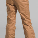 North Face Girls Freedom Insulated Pant 2024 - A pair of tan snow pants with a black waistband and white lettering that reads "THE NORTH FACE".