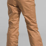 North Face Girls Freedom Insulated Pant 2024 - A pair of tan snow pants with a black waistband and white lettering that reads "THE NORTH FACE".
