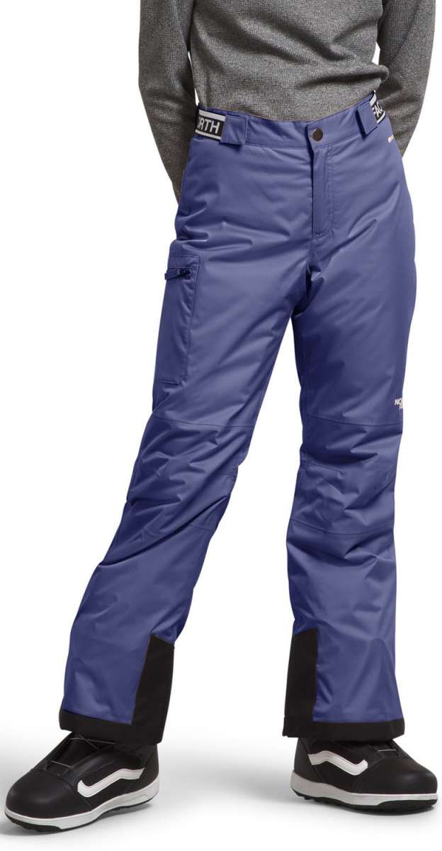 North Face Girls Freedom Insulated Pant 2024 - A pair of purple snow pants with a white logo on the left thigh and a black zipper pocket on the right leg.