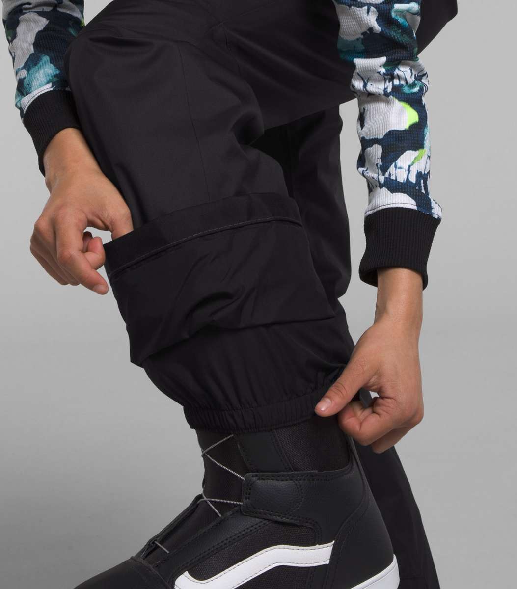 North Face Girls Freedom Insulated Pant 2024 - A pair of black insulated ski pants with a white logo on the left leg.