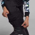 North Face Girls Freedom Insulated Pant 2024 - A pair of black insulated ski pants with a white logo on the left leg.