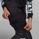 North Face Girls Freedom Insulated Pant 2024 - A pair of black insulated ski pants with a white logo on the left leg.