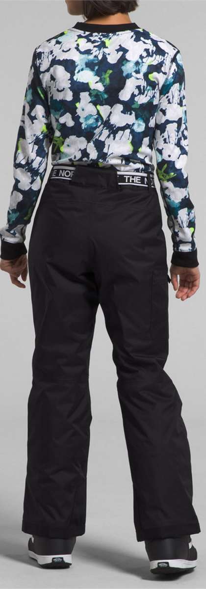 North Face Girls Freedom Insulated Pant 2024 - A pair of black snow pants with a white logo on the left leg and a green stripe down the side.