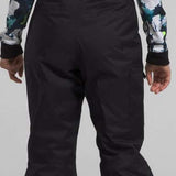 North Face Girls Freedom Insulated Pant 2024 - A pair of black snow pants with a white logo on the left leg and a green stripe down the side.