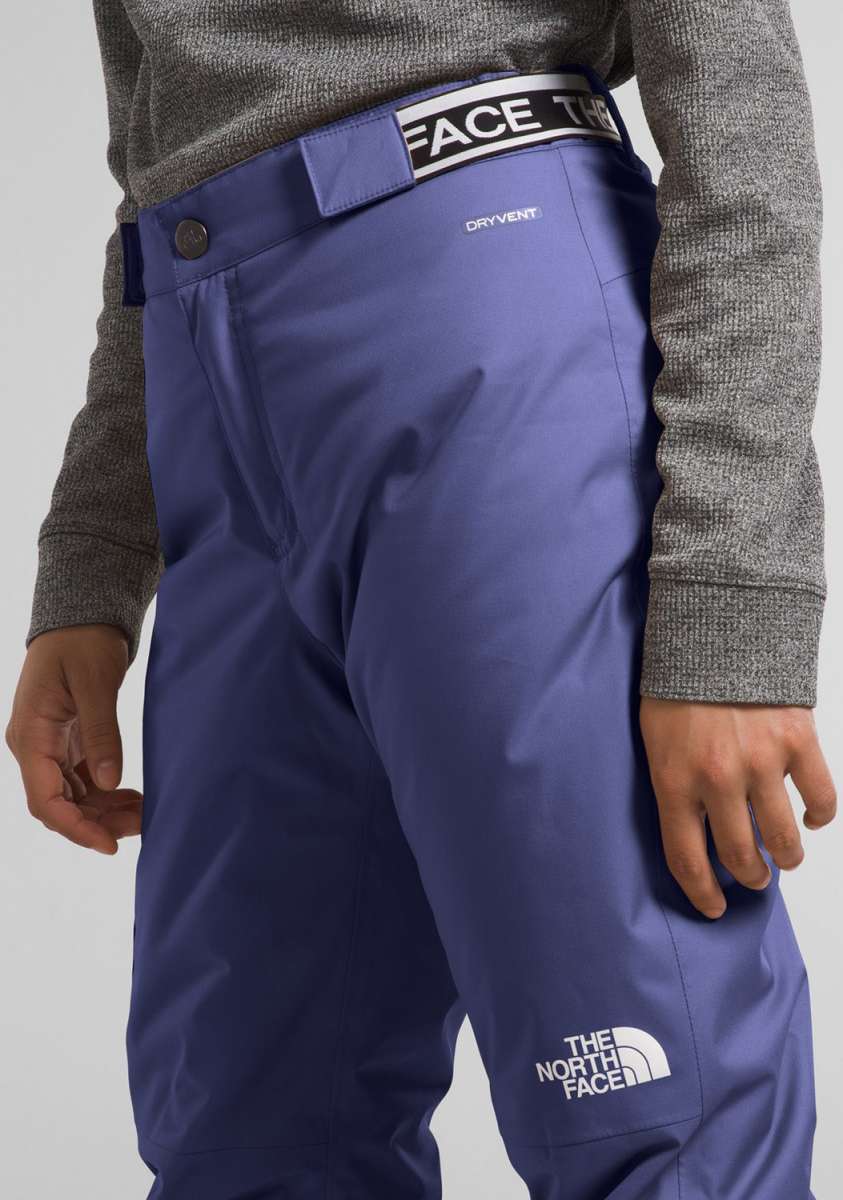 North Face Girls Freedom Insulated Pant 2024 - A pair of purple insulated ski pants with a white logo on the left leg and a black logo on the waistband.