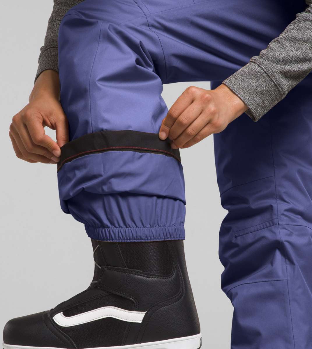 North Face Girls Freedom Insulated Pant 2024 - A pair of purple snow pants with a black waistband and elastic cuffs at the ankles.