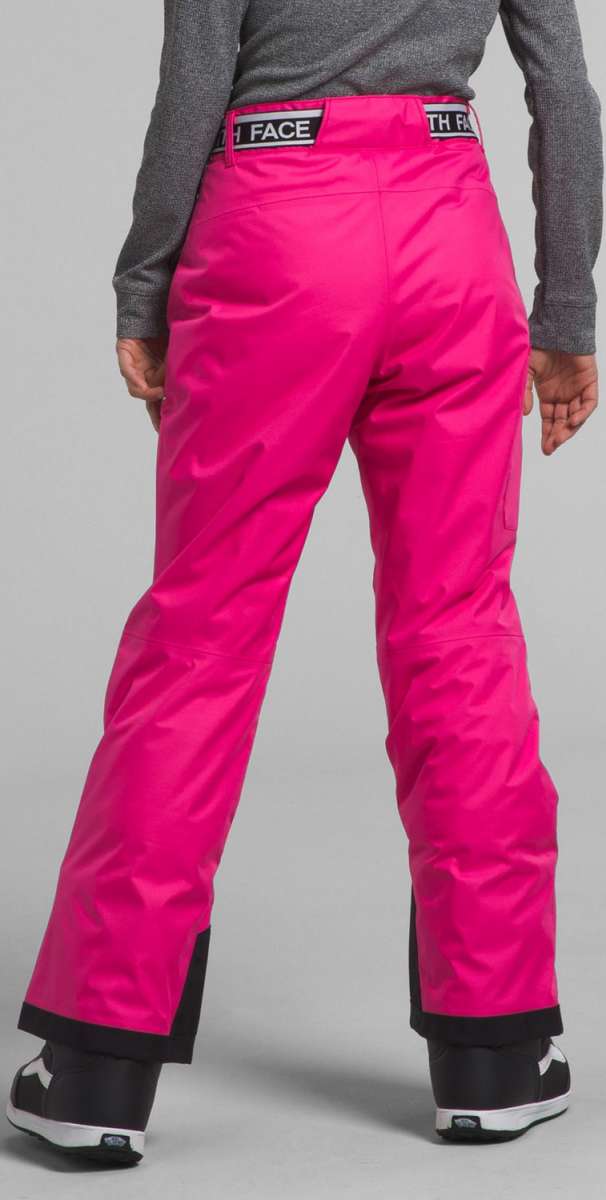 North Face Girls Freedom Insulated Pant 2024 - A pair of bright pink snow pants with a black waistband and cuffs, featuring a prominent "THE NORTH FACE" logo in white on the back.