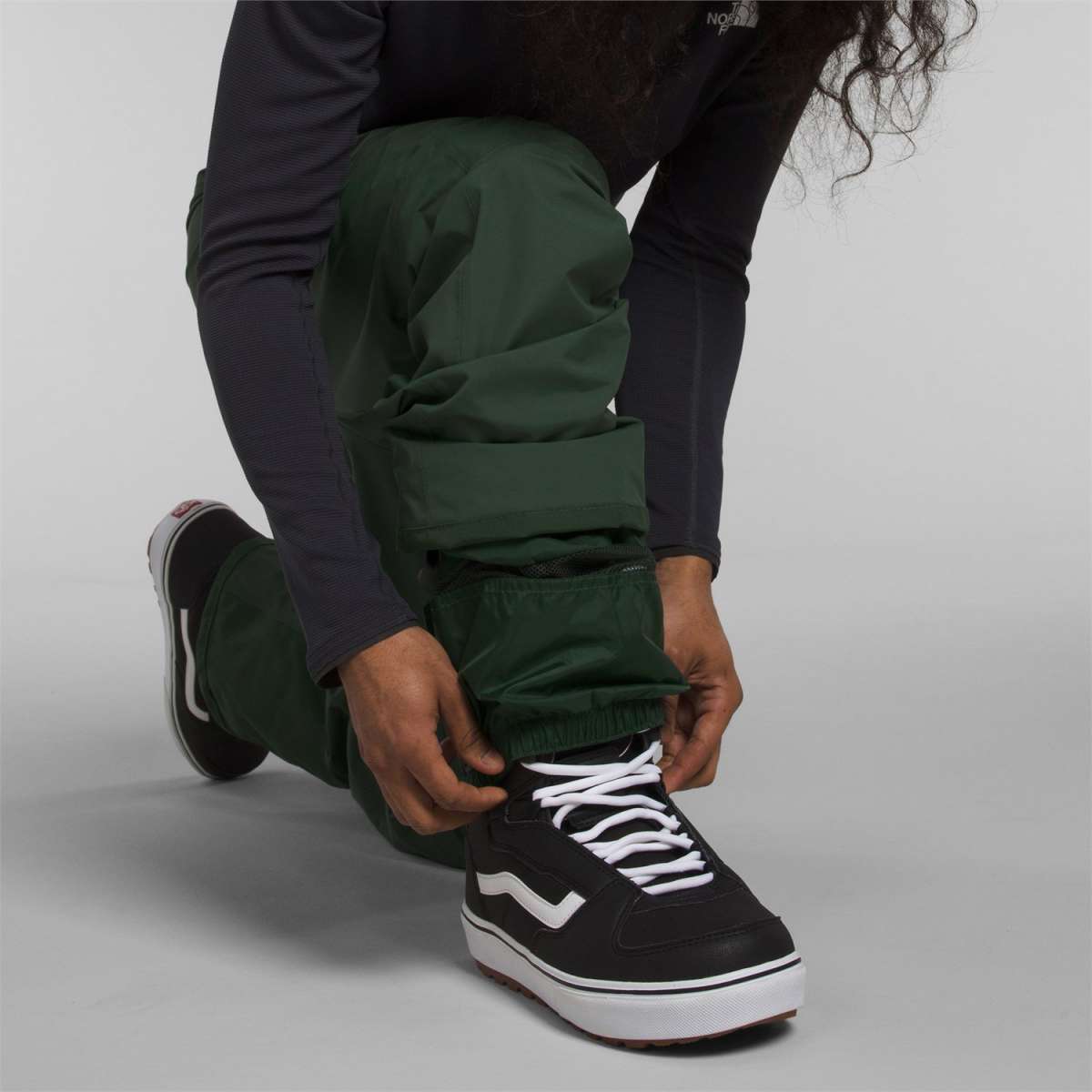 North Face Freedom Stretch Pants 2024 - Dark green pants with a subtle pattern of thin white lines on the left leg.