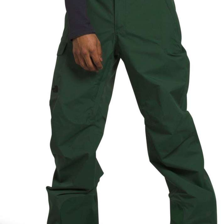 North Face Freedom Stretch Pants 2024 - Dark green pants with a subtle black logo on the left thigh and two zippered pockets on the right side.
