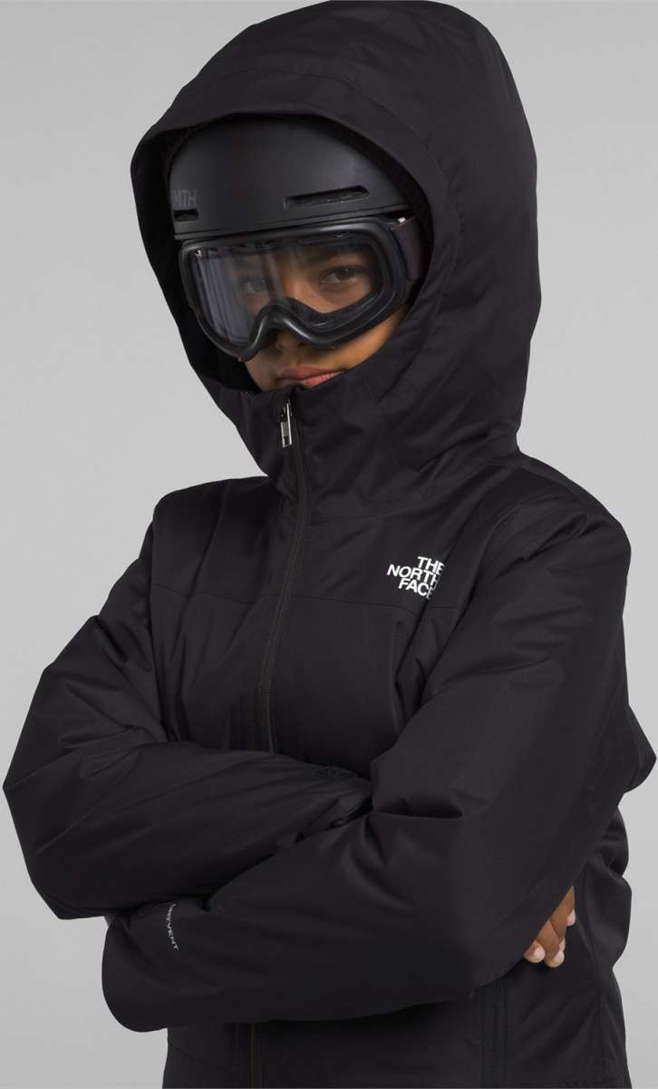 North Face Girls Freedom Insulated Jacket 2024 - A black jacket with a white logo on the left chest and a zipper down the front.