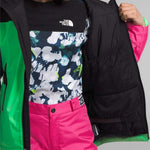 North Face Girls Freedom Insulated Jacket 2024 - A black jacket with a white logo on the chest and green accents around the hood.