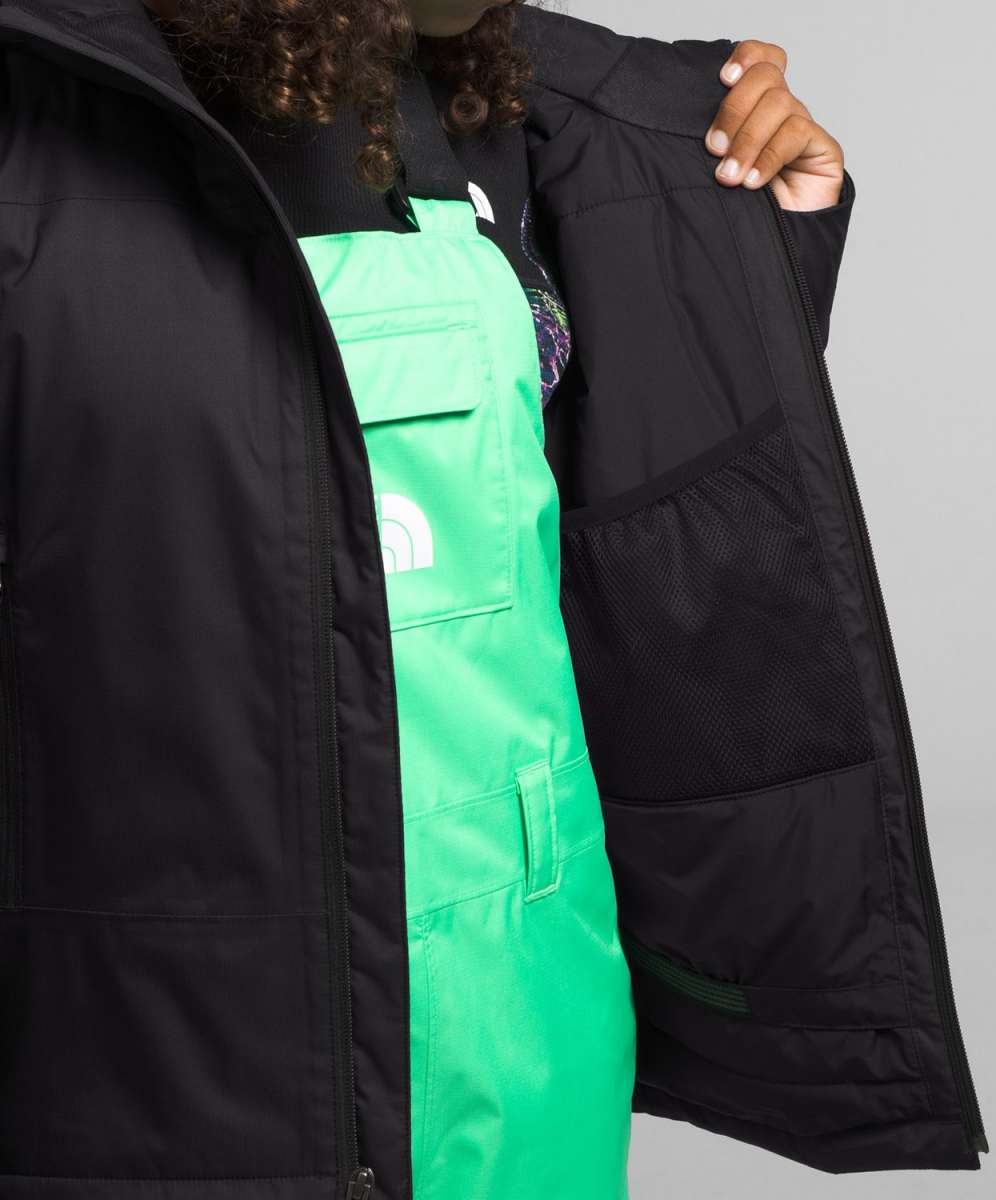 North Face Girls Freedom Insulated Jacket - A black insulated jacket with a white logo on the left chest and a zipper closure.