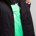 North Face Girls Freedom Insulated Jacket - A black insulated jacket with a white logo on the left chest and a zipper closure.