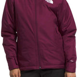 North Face Girls Freedom Insulated Jacket - A young girl wearing a purple jacket with a white logo on the left chest and black pants, standing against a light gray background.