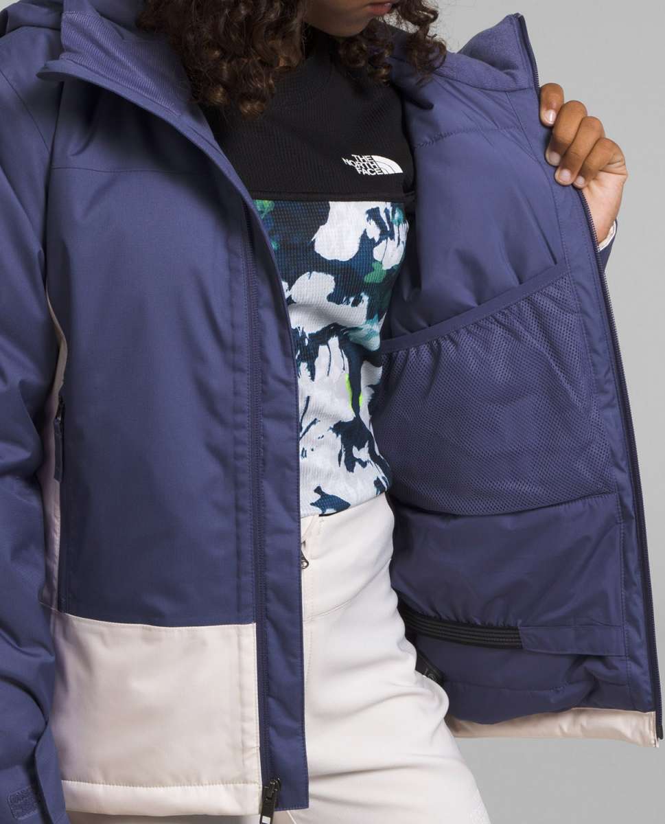 North Face Girls Freedom Insulated Jacket - A dark blue jacket with a white logo on the chest and a zipper closure.