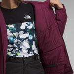 North Face Girls Freedom Insulated Jacket - A dark-colored, insulated jacket with a prominent white logo on the chest and a zipper running down the front.