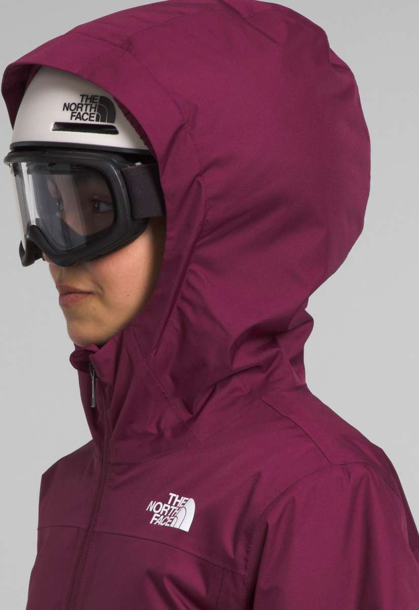 North Face Girls Freedom Insulated Jacket 2024 - A dark-colored, insulated jacket with a hood and zippered pockets on the front.