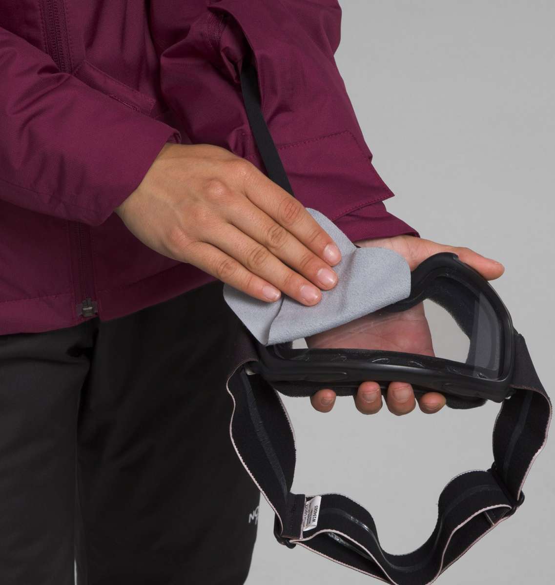 North Face Girls Freedom Insulated Jacket 2024 - A girl's insulated jacket with a bold, red and black plaid pattern on the sleeves and chest.