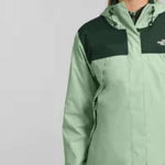 North Face Ladies Antora Triclimate Shell Jacket - A light green jacket with a darker green panel across the chest and hood, featuring a white logo on the upper left side of the chest panel.