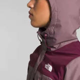 North Face Ladies Antora Triclimate Shell Jacket - A woman wearing a purple and grey jacket with a white logo on the left chest area, standing in front of a light gray background.