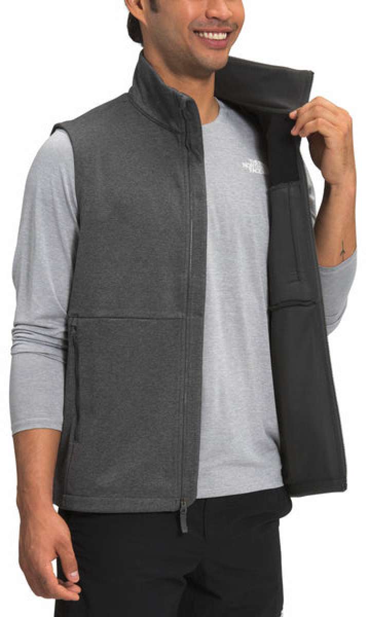 North Face Apex Canyonwall Vest - A dark gray fleece vest with a zippered front and two side pockets, worn by a model on a plain background.