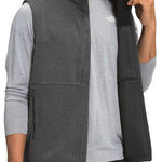 North Face Apex Canyonwall Vest - A dark gray fleece vest with a zippered front and two side pockets, worn by a model on a plain background.