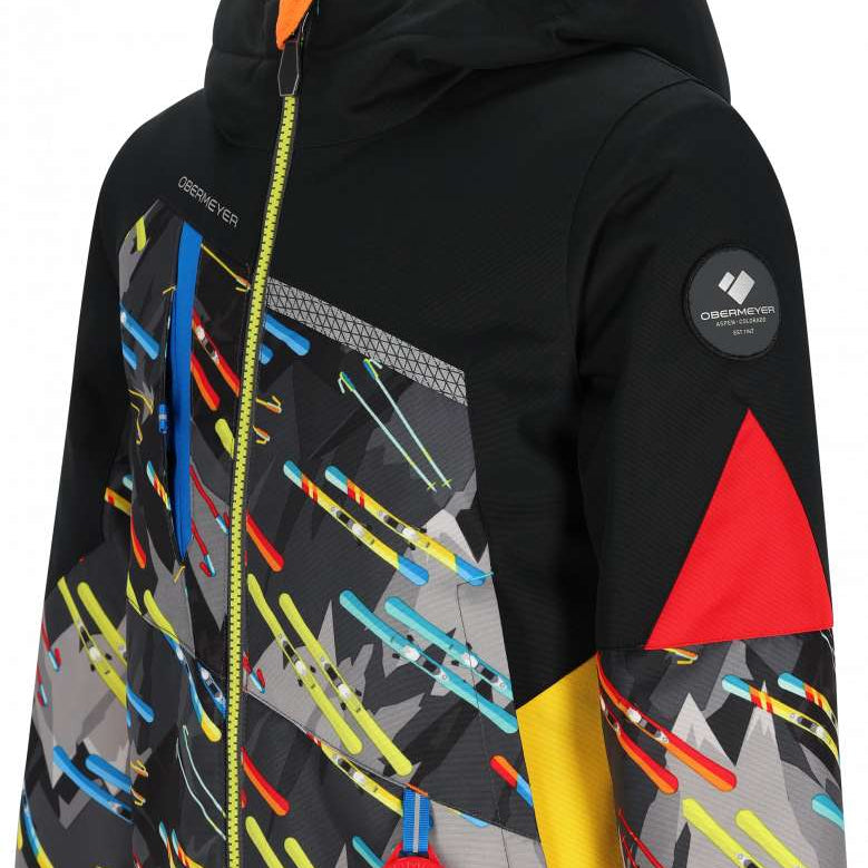 Obermeyer Juniors Orb Insulated Jacket 2024 - A black jacket with a gray pattern of diagonal stripes and ski poles, featuring yellow zippers and a red zipper pull.