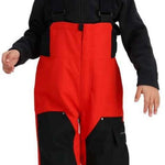 Obermeyer Juniors Volt Insulated Pant - Black snow pants with a subtle white pattern on the left leg, worn by a young girl in front of a blurred snowy background.
