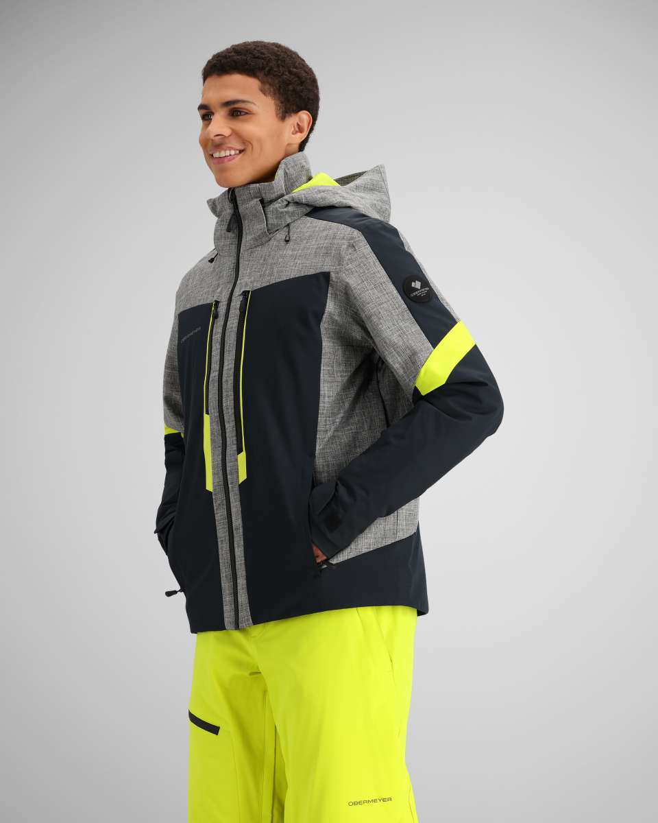 Obermeyer Fall Line Insulated Jacket 2024 - A grey and black jacket with a hood, featuring neon yellow accents on the zipper and pockets.