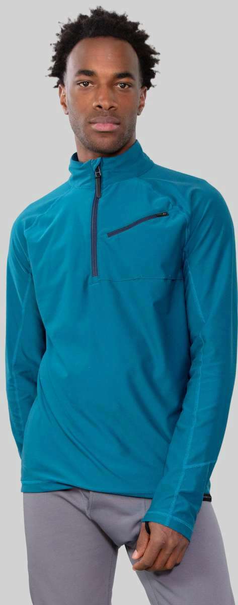 Obermeyer Flex 1/4 Zip T-Neck 2023 - A teal blue zip-up sweater with a high collar and two chest pockets, worn by a model on the left side of the image.