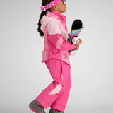 Obermeyer Kids Swirliana Insulated One Piece Suit 2024 - A pink snowsuit with a swirly pattern on the chest and sleeves, worn by a young girl holding a snowboard.