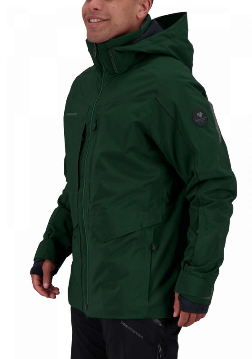 Obermeyer Kodiak Jacket 2022 - A dark green jacket with a hood, featuring two zippered pockets on the front and a black zipper running down the middle.