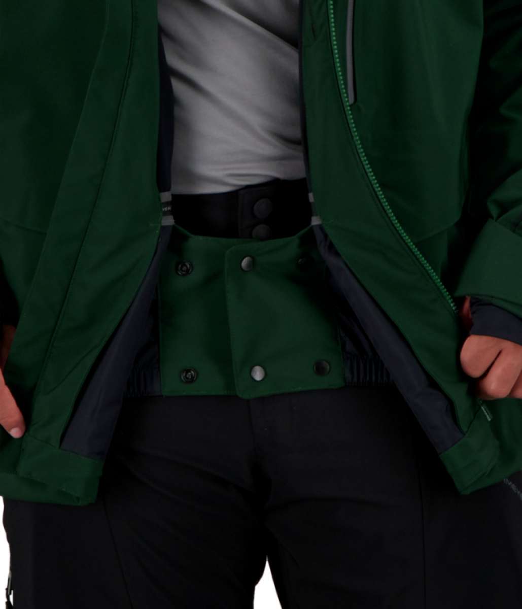 Obermeyer Kodiak Jacket 2022 - A dark green jacket with a zippered front and two side pockets, worn by a model on a plain background.