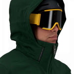 Obermeyer Kodiak Jacket 2022 - A dark green ski jacket with a hood, featuring a zippered front and two zippered pockets on the chest.