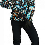 Obermeyer Women's Bombshell Down Jacket 2024 - A black down jacket with a blue, brown, and white abstract pattern.