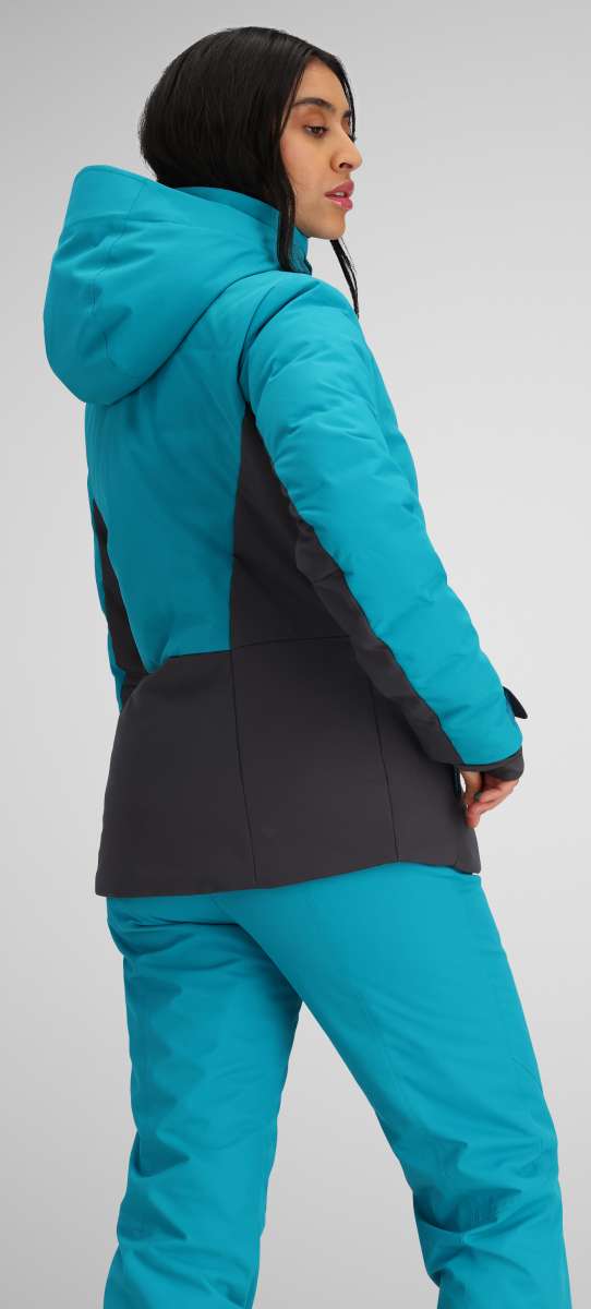 Obermeyer Women's Cosima Down Jacket - A bright blue down jacket with a high collar and zippered pockets, worn by a model facing left.