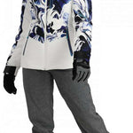 Obermeyer Women's Cosima Down Jacket 2024 - A white down jacket with a blue and black abstract pattern on the front, worn by a model posing in front of a plain background.