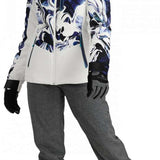 Obermeyer Women's Cosima Down Jacket 2024 - A white down jacket with a blue and black abstract pattern on the front, worn by a model posing in front of a plain background.