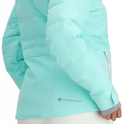 Obermeyer Women's Cosima Down Jacket 2024 - A woman with long dark hair wearing a light blue down jacket and white pants, facing left.