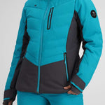 Obermeyer Women's Cosima Down Jacket - A bright blue down jacket with a high collar and zippered pockets, featuring a black logo patch on the left sleeve.