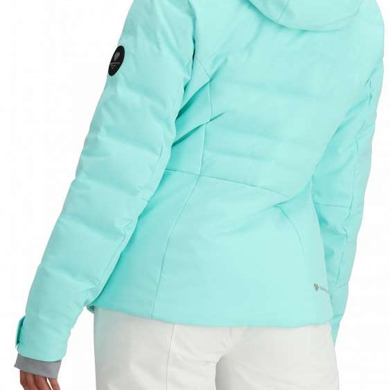 Obermeyer Women's Cosima Down Jacket - A light blue down jacket with a hood and black patch on the left sleeve.