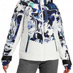 Obermeyer Women's Cosima Down Jacket - A white down jacket with a blue and black abstract pattern on the front, featuring a high collar and zippered pockets.