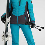 Obermeyer Women's Cosima Down Jacket - A bright blue down jacket with a high collar and zippered pockets, featuring a black zipper pull on one pocket.