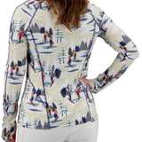 Obermeyer Women's Discover Quarter Zip Top 2024 - A cream-colored quarter-zip top with a repeating pattern of skiers and snowboarders in red, yellow, blue, and gray against a white background.