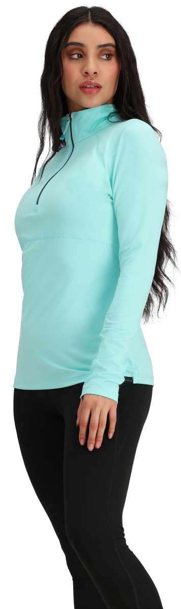Obermeyer Women's Discover Quarter Zip Top 2024 - A light blue quarter-zip top with a black zipper and collar, worn by a model on a solid white background.