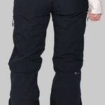 Obermeyer Women's Emily Insulated Pant Short 2023 - Black snow pants with zippered pockets and adjustable waistband, worn by a model from behind.