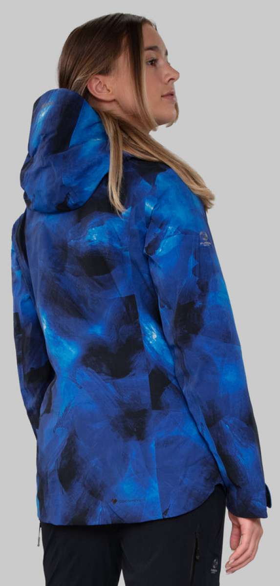 Obermeyer Women's Highlands Shell Jacket - A blue and black jacket with a hood, worn by a woman with long blonde hair.