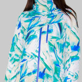 Obermeyer Women's Jette Insulated Jacket 2022-2023 - A white jacket with a blue and green abstract pattern, featuring a high collar and zippered pockets.